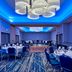 Hilton Garden Inn Livermore meeting room with round banquet tables, blue chairs, and blue-lit ceiling