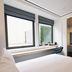 Page8 hotel room in London with large windows and wall-mounted TV