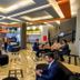 Minas Garden Hotel in Poços de Caldas lobby with seating area, tables, and guests