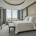 Four Seasons Hotel One Dalton Street, Boston guest room with floor-to-ceiling city view and bed by window