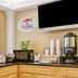 Super 8 by Wyndham Jacksonville Orange Park breakfast area with TV, coffee station and cereal dispenser in Jacksonville