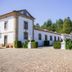 Hotel Rural Casa de Samaioes in Chaves, white rural hotel with cobblestone courtyard and manicured hedges