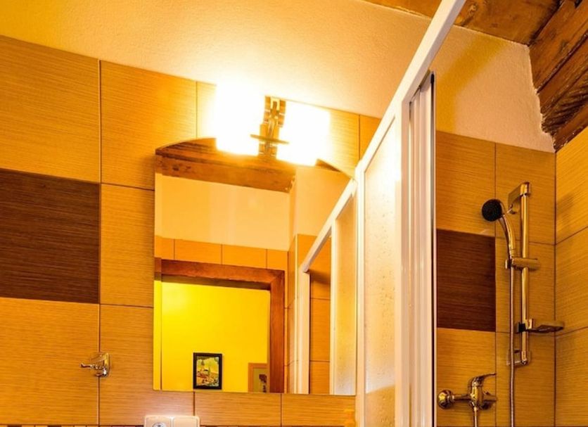 Ubytování Zámecké Schody bathroom with sink, shower and brown tiled walls in Český Krumlov