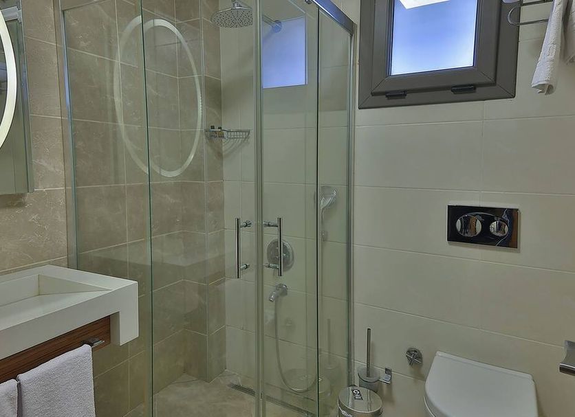 Buca Residence Hotel Izmir bathroom with glass shower, vanity sink and toilet