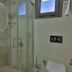 Buca Residence Hotel Izmir bathroom with glass shower, vanity sink and toilet