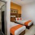 Hotel Poncowinatan - Tugu Yogyakarta room with two twin beds and an attached bathroom