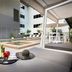 Grand Hotel and Apartments Townsville poolside cabana lounge with outdoor pool and dining area