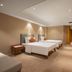 Wanhao International Hotel in Benxi guest room with two beds and wall-mounted TV