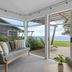 Tasman Holiday Parks - Papamoa Beach lounge opening to deck with ocean view in Papamoa