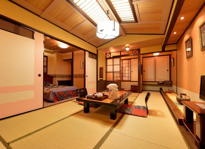 Kokonoe Yuyutei Ryokan tatami guest room with low table and futon in Kokonoe