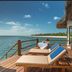 Konokono Beach Resort and Isaraya Over Water Villa deck with loungers overlooking the ocean in Michamvi