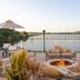 Crowne Plaza Ft. Myers Gulf Coast in Fort Myers, rooftop fire pit lounge with lake view