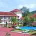 Hotel Seri Malaysia Mersing in Mersing with a pool, palm trees, and red-roofed buildings