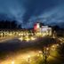 Spa Hotel Peurunka in Laukaa at dusk, showing the illuminated entrance, circular driveway, and landscaped grounds.