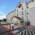 Woodspring Suites San Antonio South exterior entrance and parking area in San Antonio