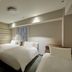 Hearton Hotel Shinsaibashi Nagahoridori in Osaka, guest room with three single beds and striped accent wall