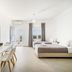 Oniropetra Apartaments in Plintri: bright room with twin beds, dining table, TV, and balcony view