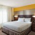 Residence Inn by Marriott Denver Central Park guest room with king bed and window with sheer curtains