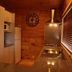 Tussock Grove Boutique in Ohakune kitchen with wood-paneled walls, fridge, stove and granite counter