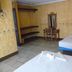 Hotel Casa Vieja in Puerto Escondido guest room with two beds, desk, mirror, and tiled floor