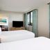 Embassy Suites by Hilton Tampa Airport Westshore guest room with two beds and city view