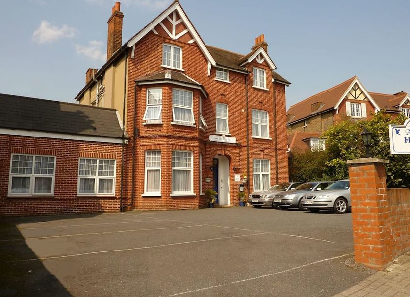 Avis Hotel in Bromley, red-brick hotel exterior with parking area and sign by the entrance