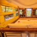 Barefoot Kuata Island bungalow with bed, open windows, and tropical island views in Kuata Island