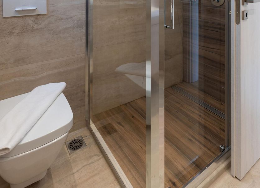Plakias Resorts in Plakias bathroom with glass shower enclosure and toilet