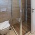 Plakias Resorts in Plakias bathroom with glass shower enclosure and toilet