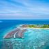Kagi Maldives Resort & Spa in Kagi with overwater villas and a turquoise lagoon island view