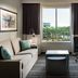 Homewood Suites by Hilton Aliso Viejo - Laguna Beach room with sofa, desk, and palm tree view