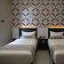 Malang City Boulevard in Malang: twin beds with patterned headboards in a simple guest room
