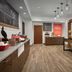 Hampton Inn Yorkville breakfast area with waffle station, hot food buffet and wood flooring