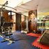 Hotel Shipra International New Delhi gym with treadmill, weight machine, and exercise platform