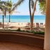 Oasey Beach Hotel in Bentota with palm trees, lounge chairs, and a view of the beach and sea