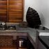 Villas Sur Mer in Negril kitchen nook with microwave, kettle, stovetop, and wooden shutters