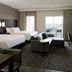 Residence Inn by Marriott Montreal Airport room with two beds, seating area, and balcony view