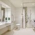 Premier Inn Newcastle Airport bathroom with walk-in shower, bathtub, toilet and sink in Newcastle upon Tyne