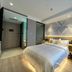 Mingcheng Hotel Beijing guest room with a bed, desk, chair, and entrance view in Beijing
