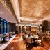 The Westin Wuhan Wuchang restaurant with polished wood floors, tables, and tall wine display shelves in Wuhan