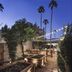 Andaz Scottsdale Resort & Bungalows courtyard at dusk with string lights, palm trees, and outdoor seating