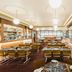 Statesman Hotel Canberra dining room with tables, bar counter and pendant lighting