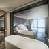 Tastoria Collection Sukhumvit in Bangkok: spa-style bathroom with freestanding tub and bedroom view