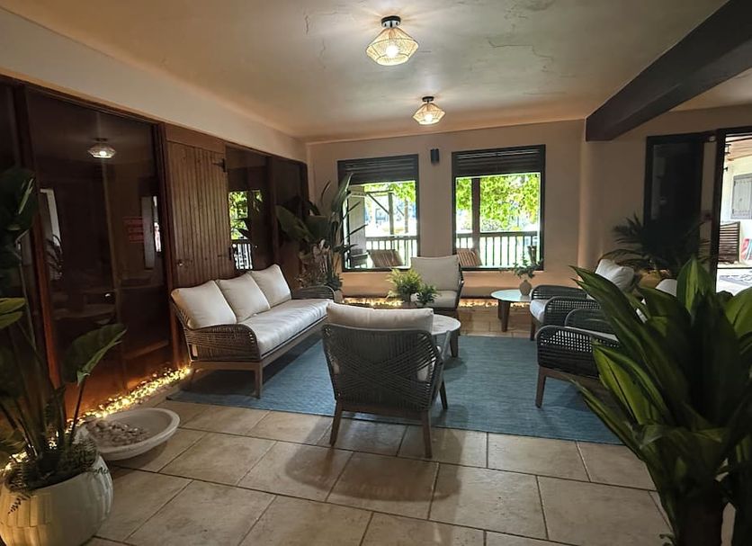 Hacienda el Jibarito in San Sebastián lobby lounge with sofas, chairs, potted plants and tiled floor