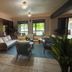Hacienda el Jibarito in San Sebastián lobby lounge with sofas, chairs, potted plants and tiled floor
