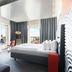 Solo Sokos Hotel Torni Tampere guest room with city views, bed, desk and TV in Tampere