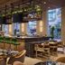 The Leo Kent Hotel, Tucson, a Tribute Portfolio Hotel bar with green stools and modern lounge seating