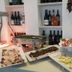 Hotel Marinella in Ricadi breakfast buffet with pastries, savory dishes and wine bottles on shelves