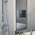 Amrise Hotel Kitchener Singapore bathroom with glass shower beside bedroom reflection