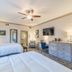 The Beaufort Inn guest room in Beaufort with two beds, ceiling fan, and dresser